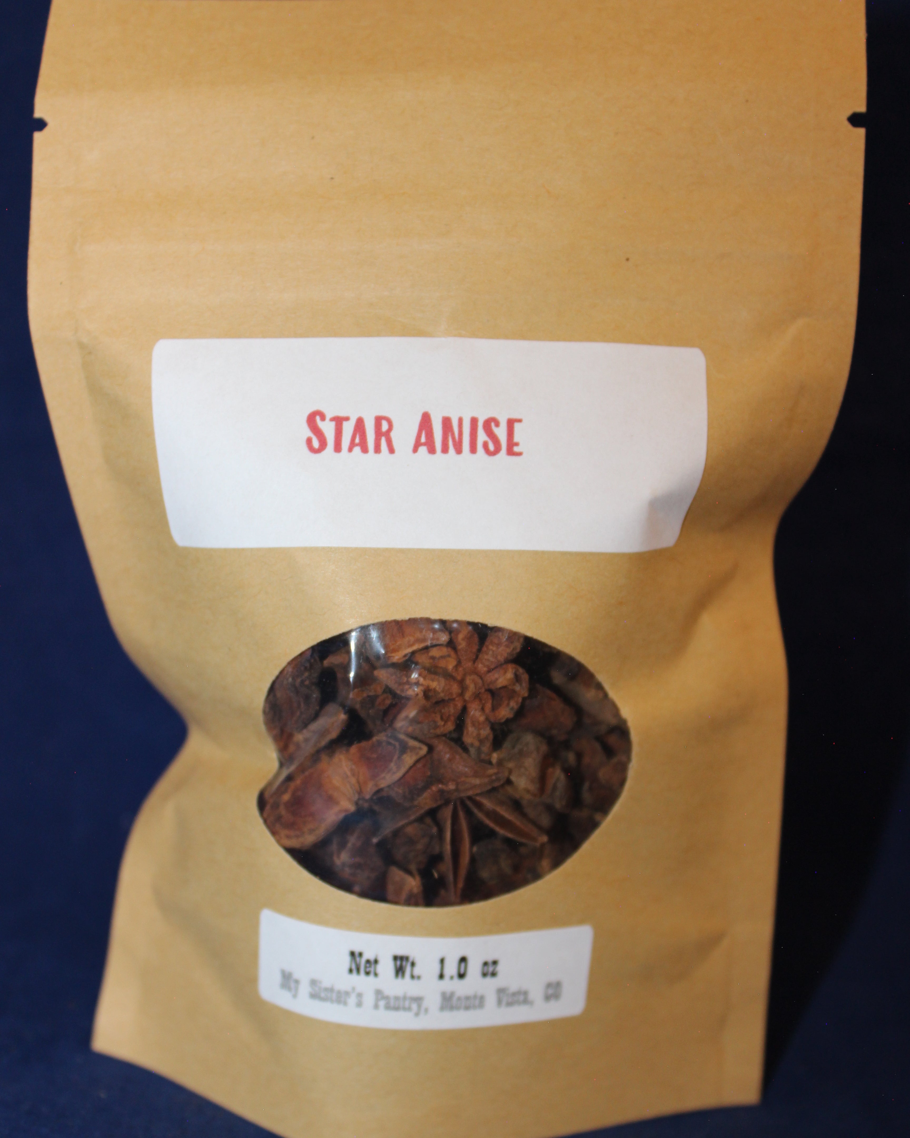 Bag of star anise with a label on a dark background