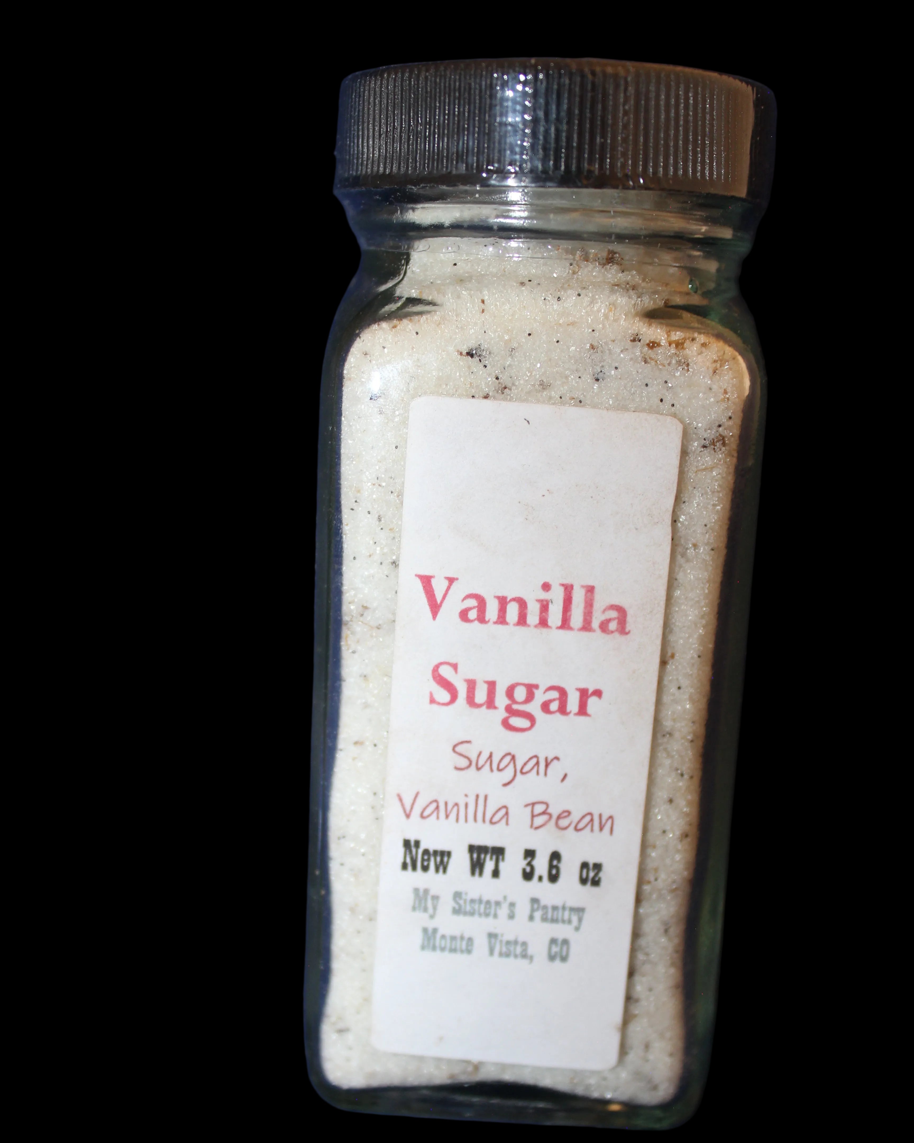 Jar of vanilla sugar with a label on a dark blue background