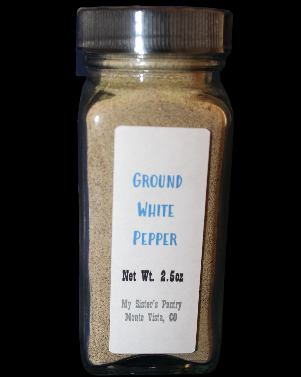 Jar of ground white pepper with a label 