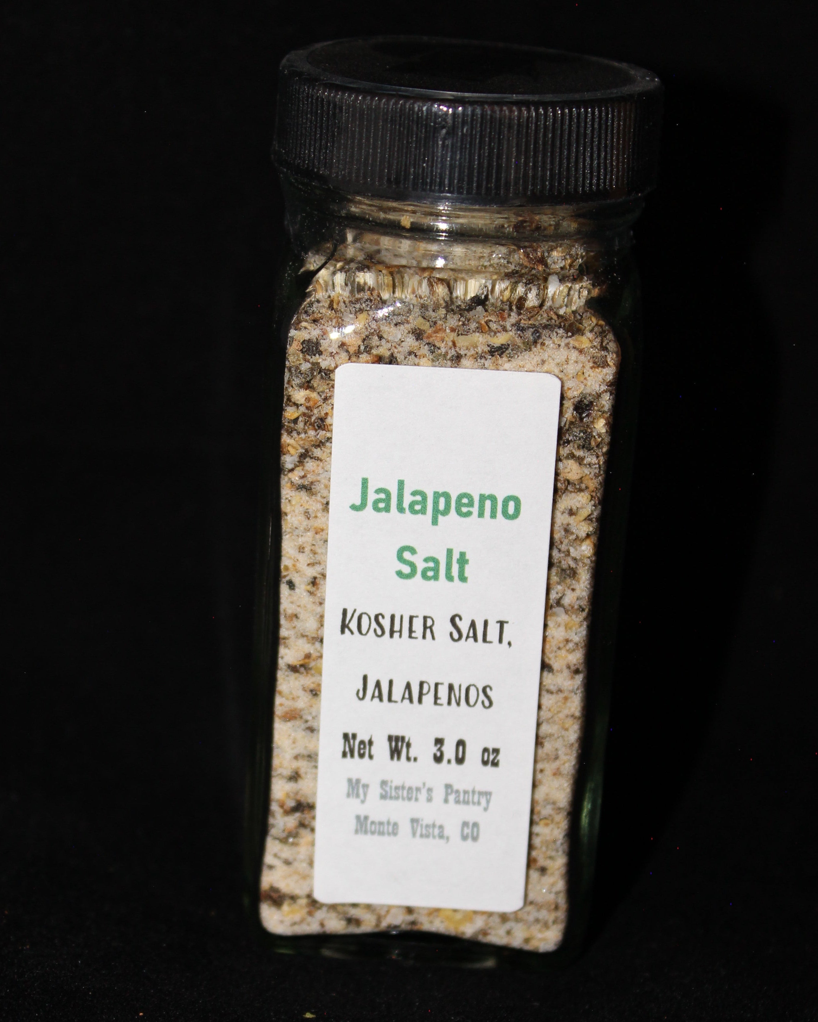 Jar of kosher salt with a label on a black background