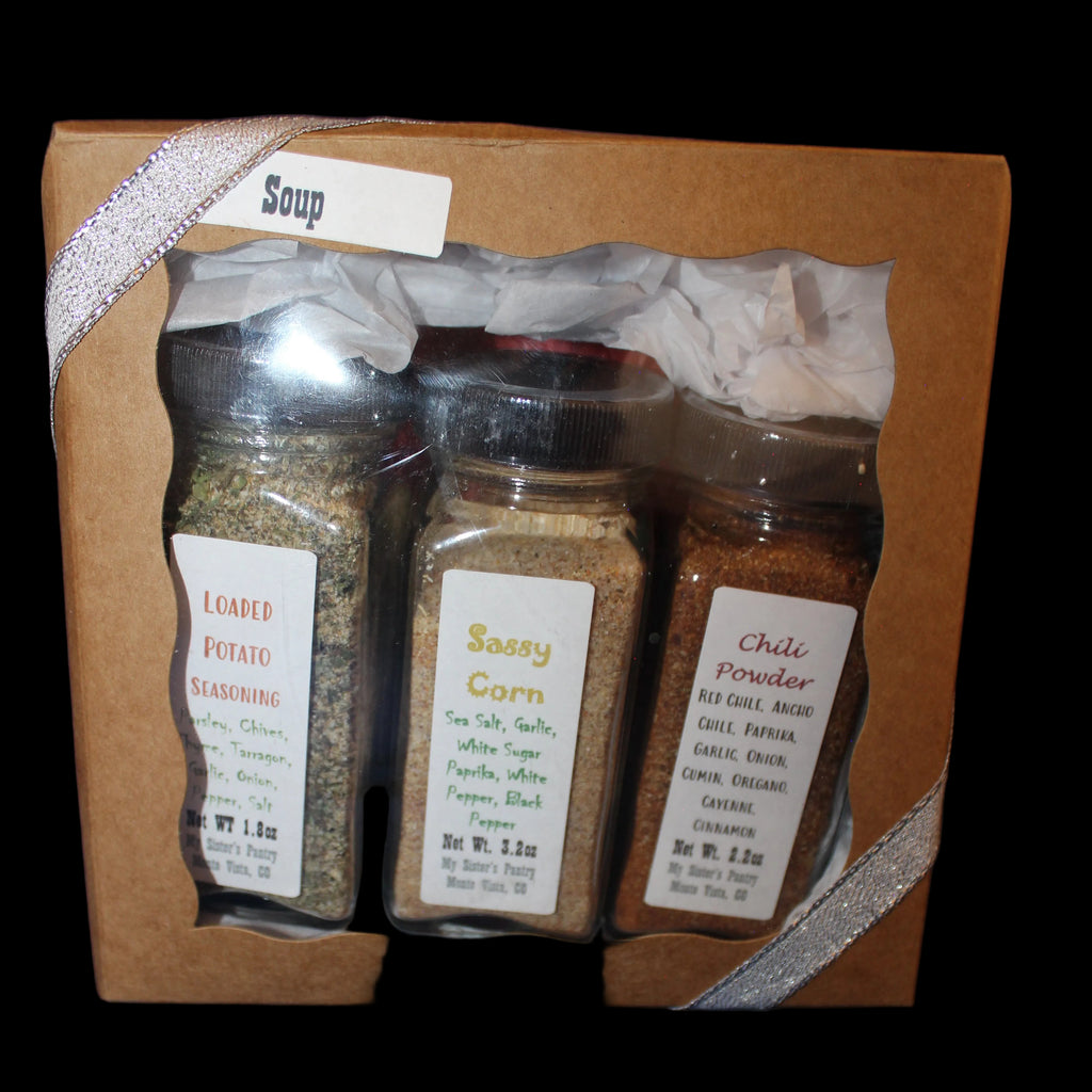 Spice set in a cardboard box with labels on a dark background