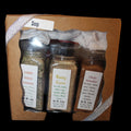 Spice set in a cardboard box with labels on a dark background