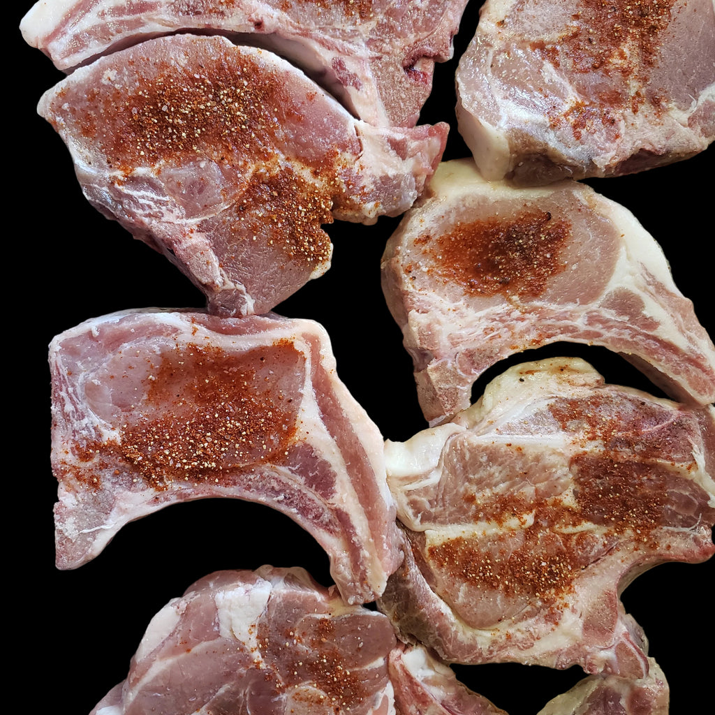 Raw pork chops seasoned with sweet and smokey seasoning