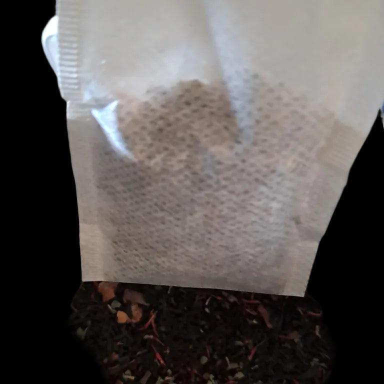 Tea bag in a container with loose tea leaves