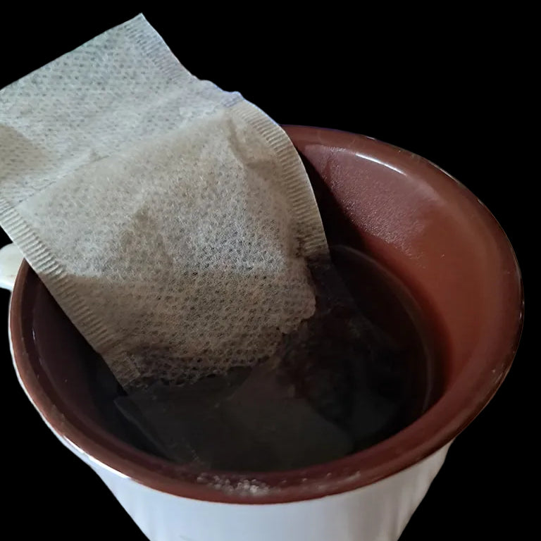 Tea bag in a cup of hot water 